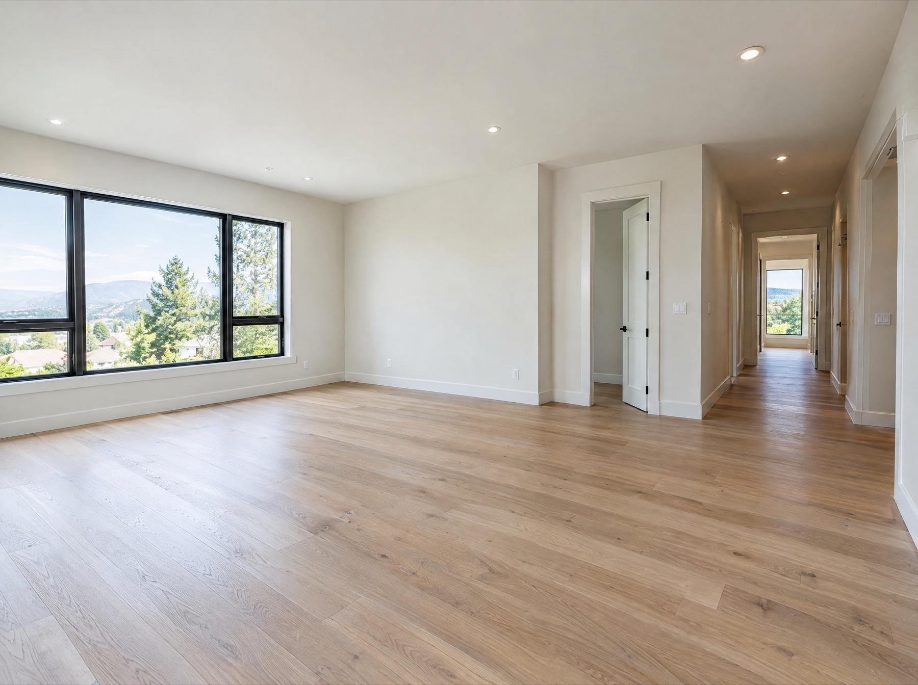 Finished interior with oak floors, painted walls and large windows