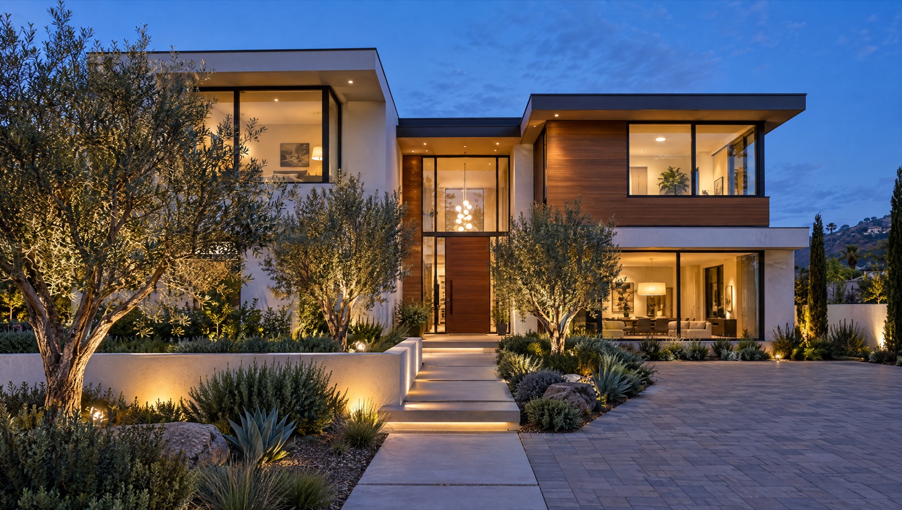 Modern two-story building at blue hour with warm interior lights